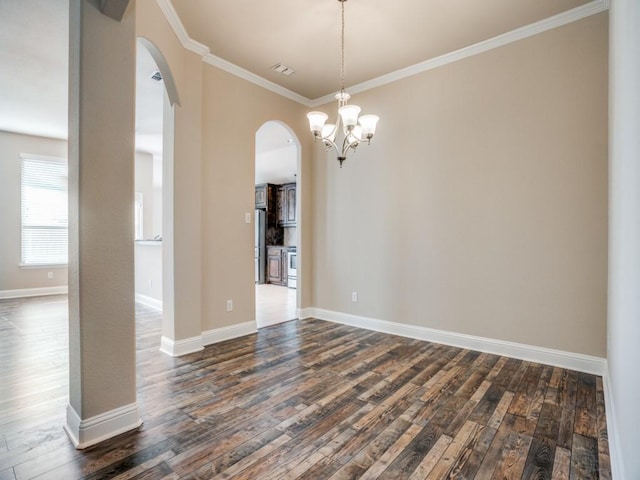 empty room with baseboards, arched walkways, dark wood finished floors, and ornamental molding