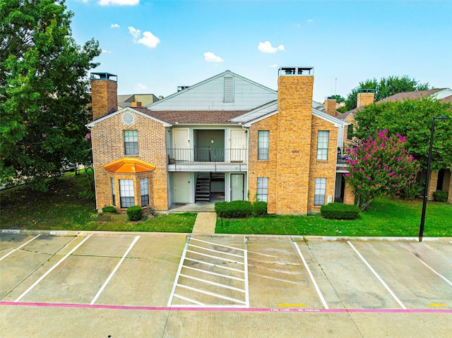 view of property featuring uncovered parking