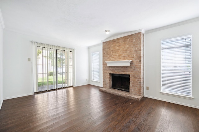 unfurnished living room featuring a brick fireplace, baseboards, ornamental molding, and dark wood-type flooring