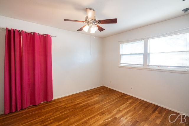 empty room featuring hardwood / wood-style floors and ceiling fan