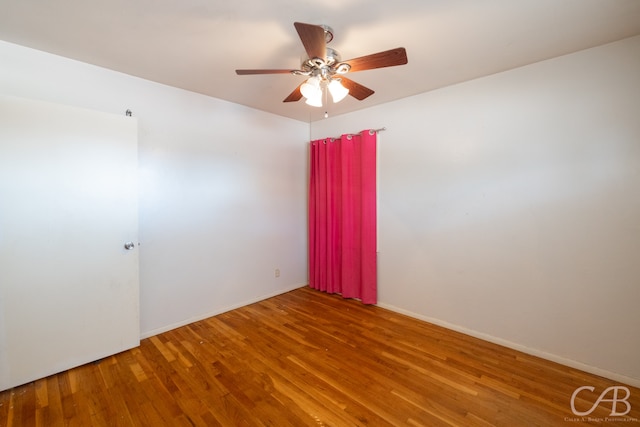 spare room featuring ceiling fan and wood-type flooring