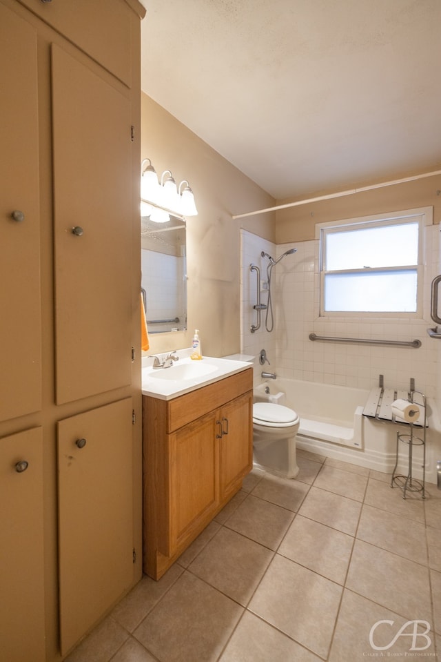 full bathroom with tiled shower / bath combo, vanity, tile patterned flooring, and toilet