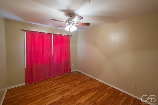 spare room with ceiling fan and wood-type flooring