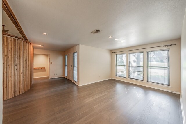 spare room featuring dark hardwood / wood-style floors