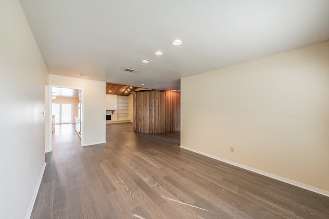 unfurnished living room with dark wood-type flooring