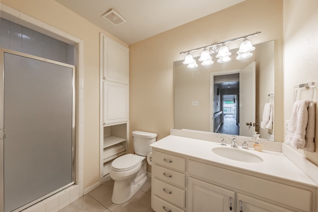 bathroom with vanity, tile patterned floors, a shower with shower door, and toilet