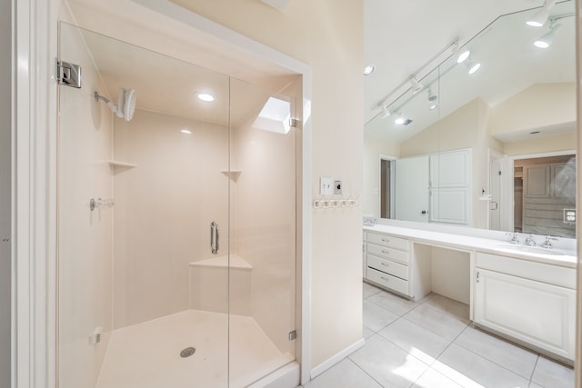 bathroom featuring vanity, tile patterned floors, vaulted ceiling, and a shower with door