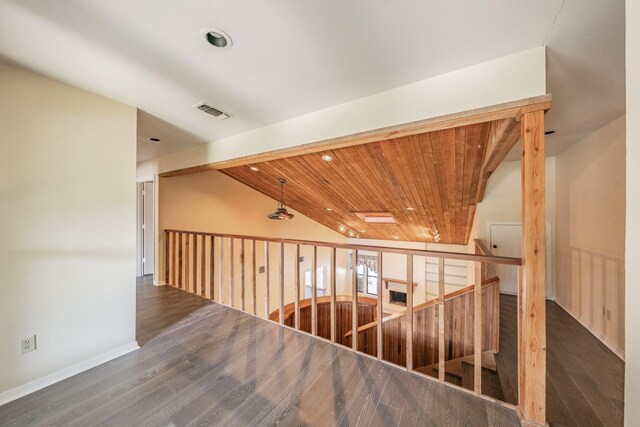 hall with lofted ceiling, dark hardwood / wood-style floors, and wooden ceiling