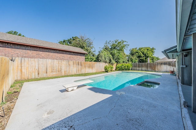 view of pool featuring a patio and a diving board