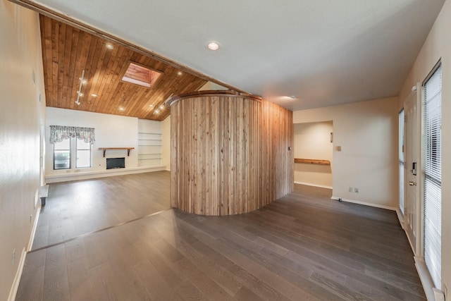 unfurnished living room featuring a fireplace with raised hearth, wooden ceiling, baseboards, lofted ceiling with skylight, and dark wood finished floors