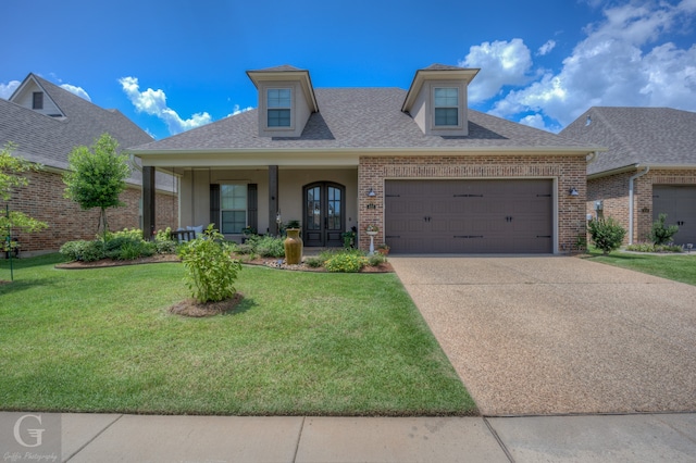 view of front facade with a garage and a front lawn