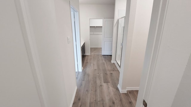 corridor featuring light hardwood / wood-style floors