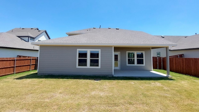 rear view of house featuring a lawn and a patio area