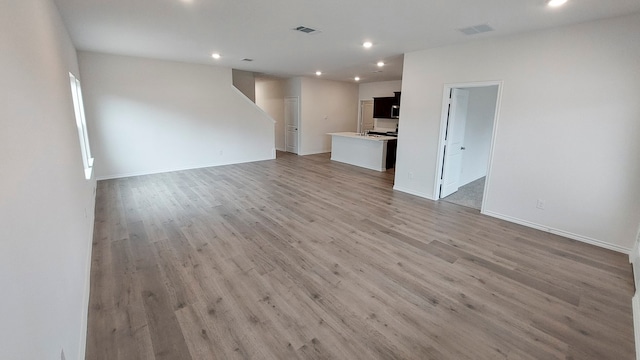 unfurnished living room featuring light hardwood / wood-style floors