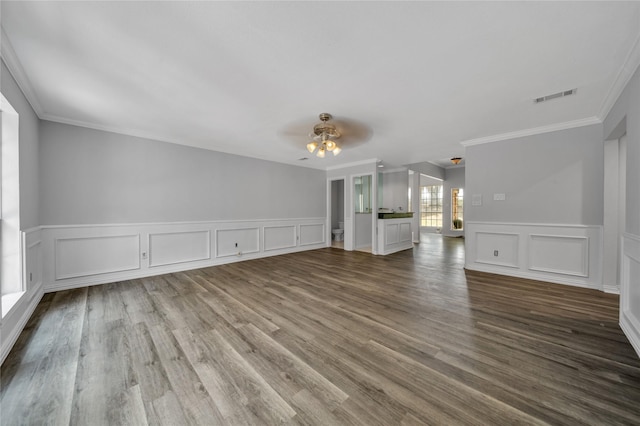 unfurnished living room with visible vents, ornamental molding, ceiling fan, and wood finished floors