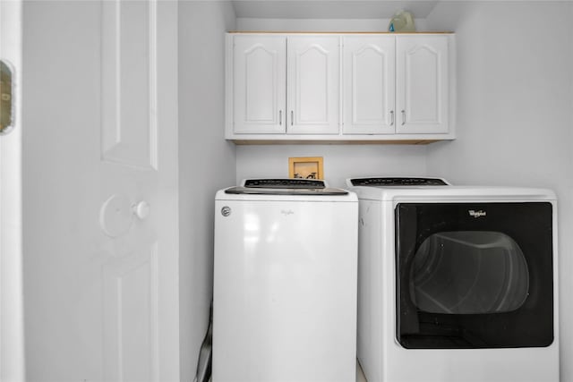 washroom featuring cabinet space and separate washer and dryer