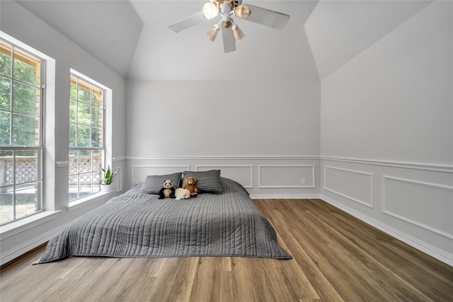 bedroom featuring lofted ceiling, wood finished floors, and a ceiling fan