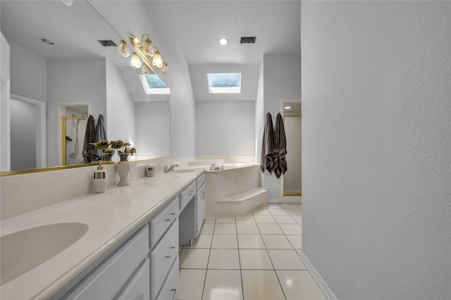 bathroom featuring tile patterned floors, a skylight, a garden tub, and a sink