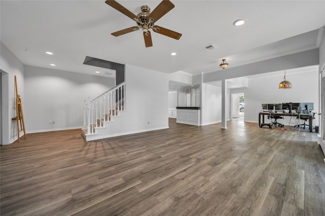 unfurnished living room featuring visible vents, baseboards, stairway, recessed lighting, and wood finished floors