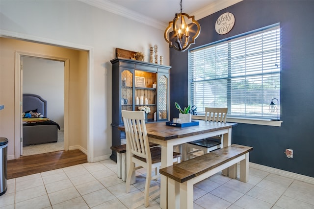 tiled dining room featuring a notable chandelier and crown molding