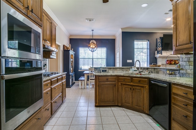 kitchen with sink, hanging light fixtures, light tile patterned flooring, stainless steel appliances, and a chandelier