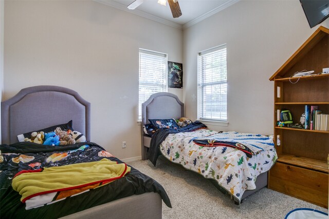 carpeted bedroom featuring ceiling fan and crown molding