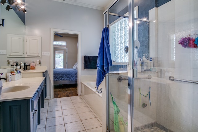 bathroom featuring tile patterned floors, vaulted ceiling, shower with separate bathtub, vanity, and ornamental molding