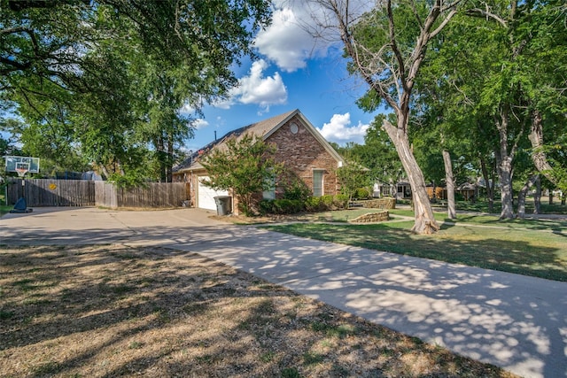 view of front of property featuring a garage and a front lawn