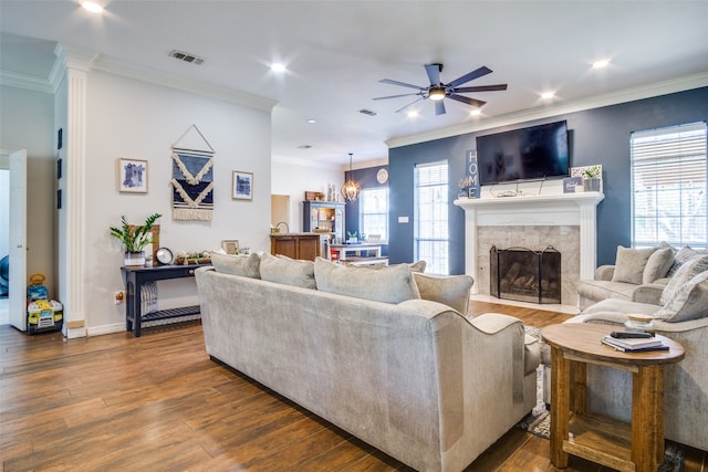 living room featuring ceiling fan with notable chandelier, dark hardwood / wood-style flooring, and crown molding