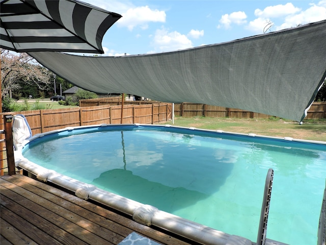 view of swimming pool with a deck