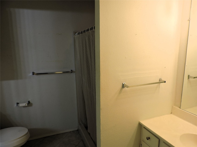 bathroom with vanity, tile patterned flooring, and toilet