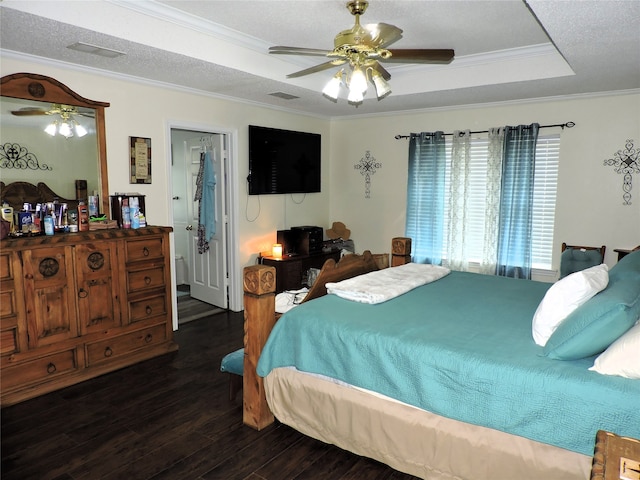 bedroom featuring ceiling fan, a raised ceiling, dark wood-type flooring, and crown molding