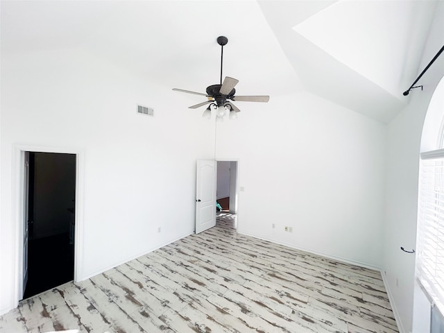 spare room with high vaulted ceiling, visible vents, ceiling fan, and light wood finished floors