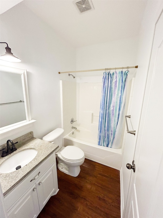 full bathroom with shower / tub combo, vanity, toilet, and hardwood / wood-style flooring