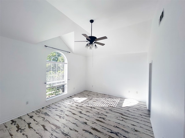 carpeted empty room featuring ceiling fan and high vaulted ceiling