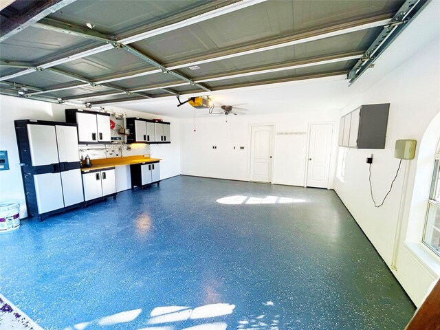 garage featuring ceiling fan and a garage door opener