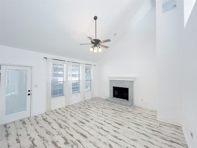 unfurnished living room featuring ceiling fan, a fireplace, and high vaulted ceiling