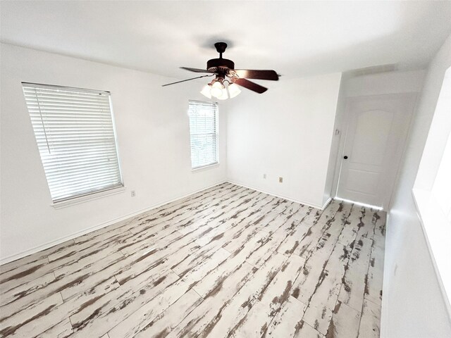 spare room featuring ceiling fan and light hardwood / wood-style flooring