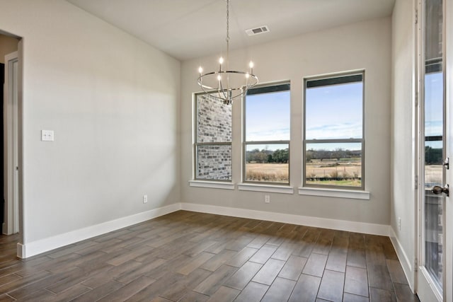 unfurnished dining area featuring a chandelier