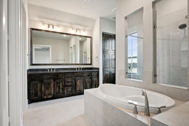 bathroom with plus walk in shower, tile patterned flooring, and vanity