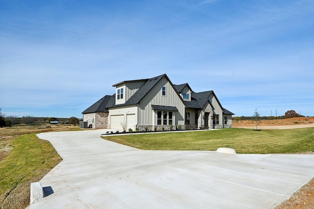 modern inspired farmhouse with a front lawn and a garage