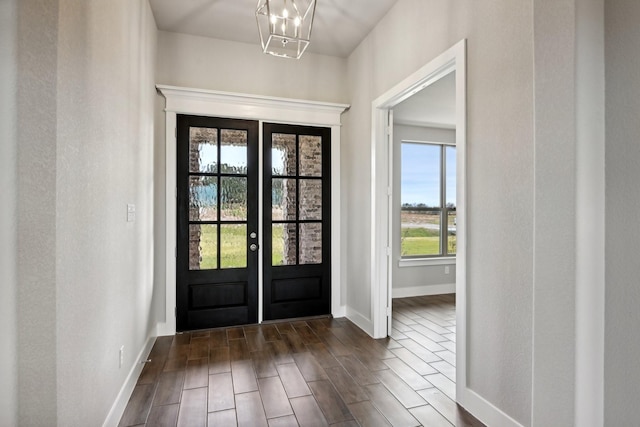 entryway featuring a chandelier and french doors