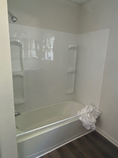 bathroom featuring shower / bathing tub combination and hardwood / wood-style floors