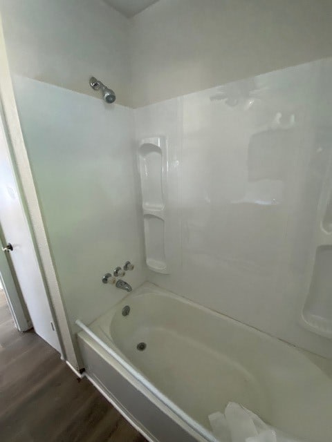 bathroom with shower / bath combination and hardwood / wood-style flooring