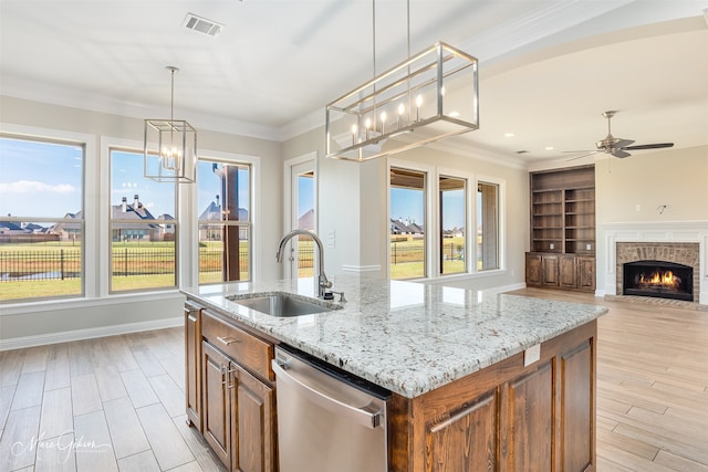 kitchen featuring a center island with sink, dishwasher, pendant lighting, and sink