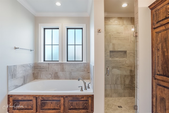 bathroom featuring ornamental molding and independent shower and bath