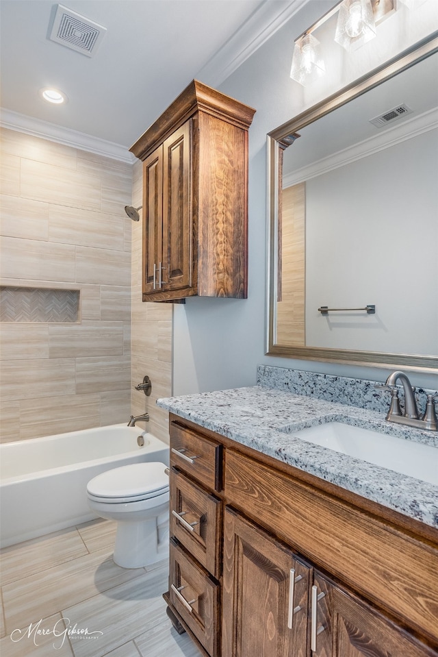 full bathroom with crown molding, vanity, toilet, and tiled shower / bath