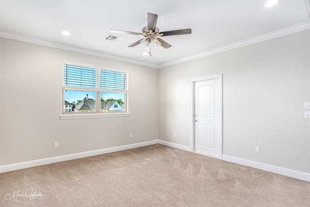 carpeted spare room with ornamental molding and ceiling fan