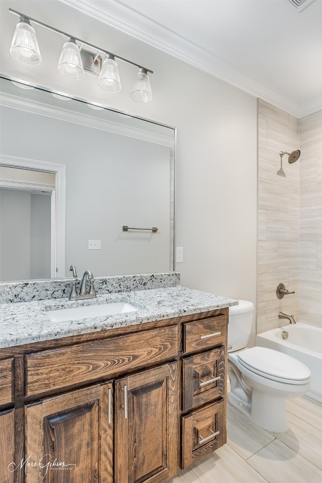 full bathroom featuring ornamental molding, tiled shower / bath combo, vanity, and toilet