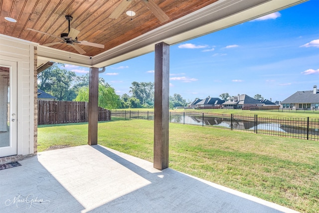 view of patio with ceiling fan and a water view